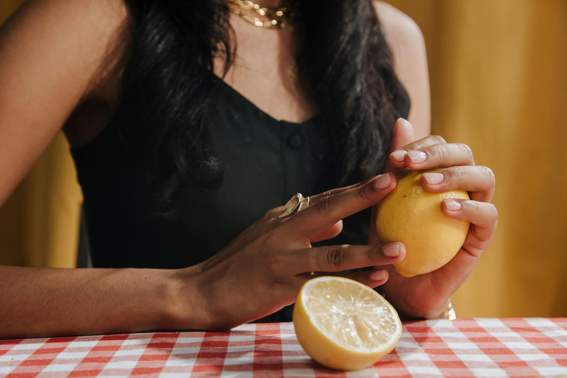 Close-up of fresh lemon in hands, symbolizing the bright potential of pleasure at any age