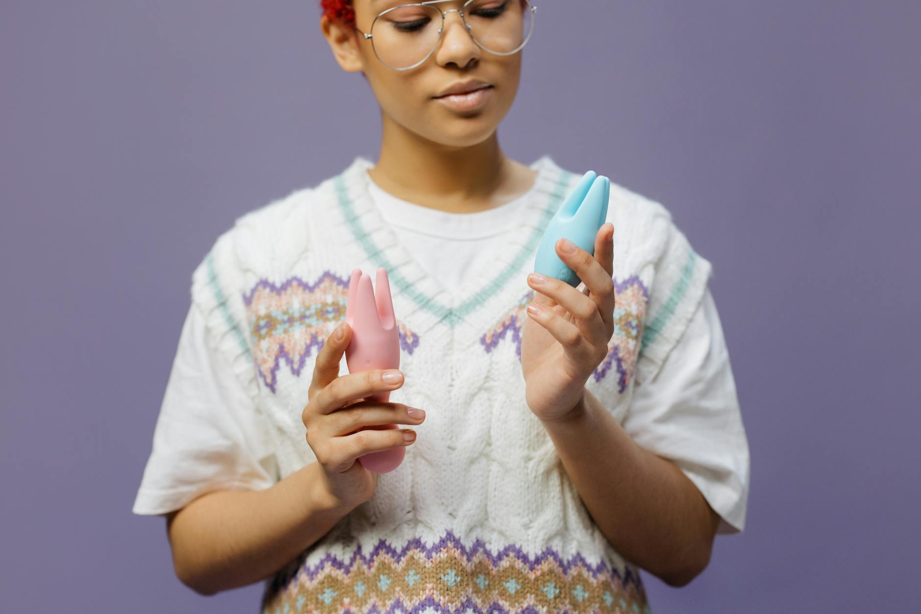 Woman exploring clitoral vibrator techniques in a contemplative, intentional moment