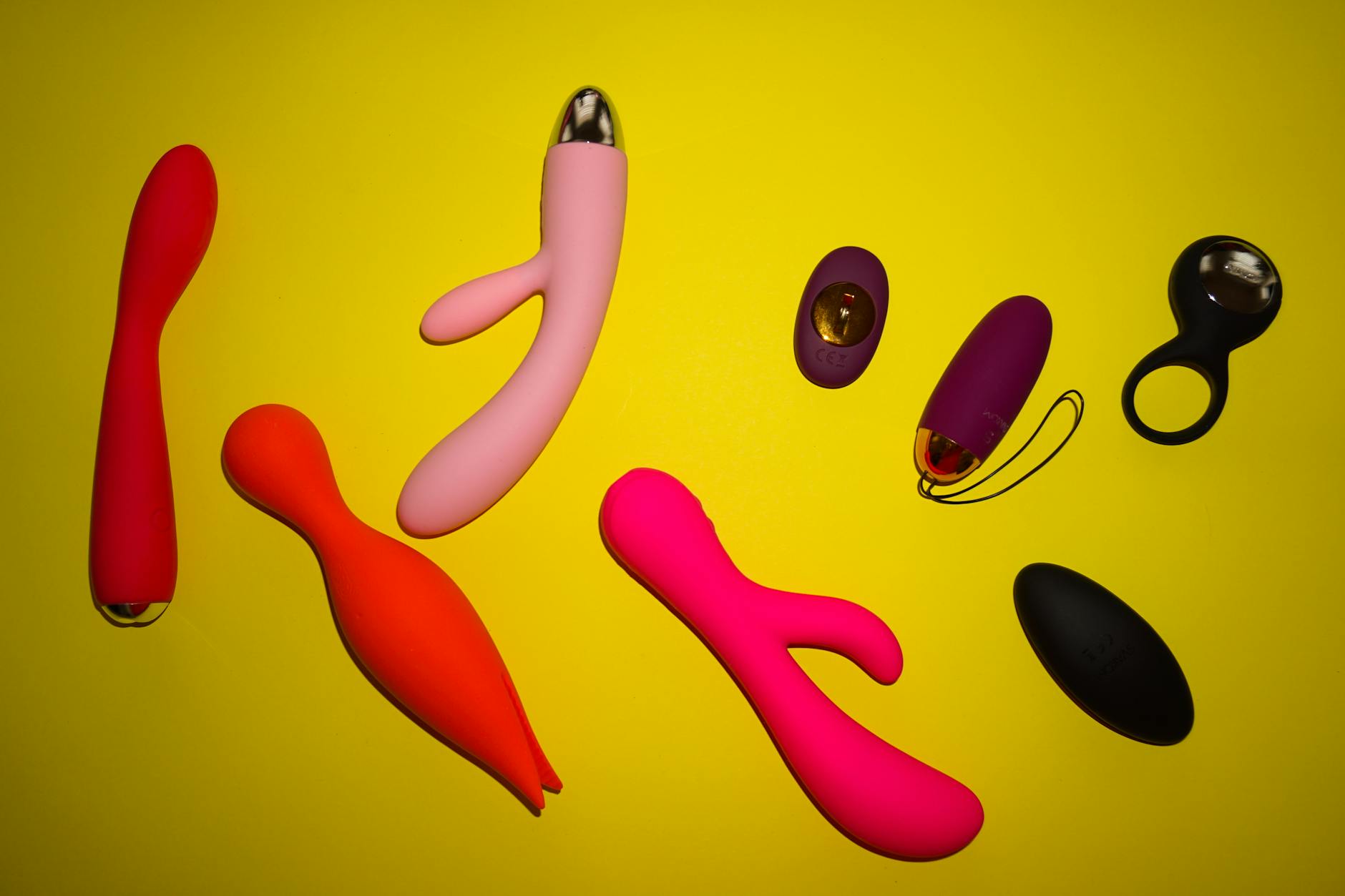 Vibrant collection of lemon-colored and various adult toys arranged on a bright yellow surface