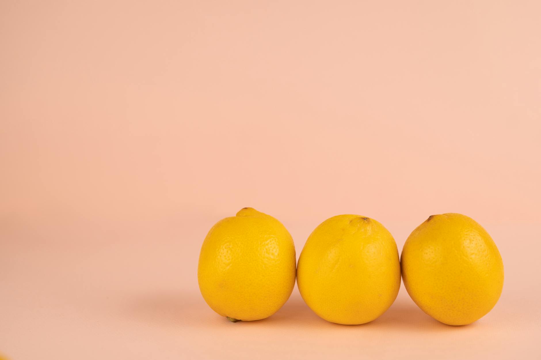 Bright ripe lemons arranged on a pastel background, symbolizing renewed sensation and vitality